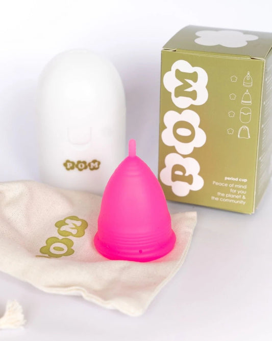 POM Super Soft Menstrual Cup in hot pink, made from 100% medical-grade silicone, featuring ribbed edges and a shorter stem for added comfort.